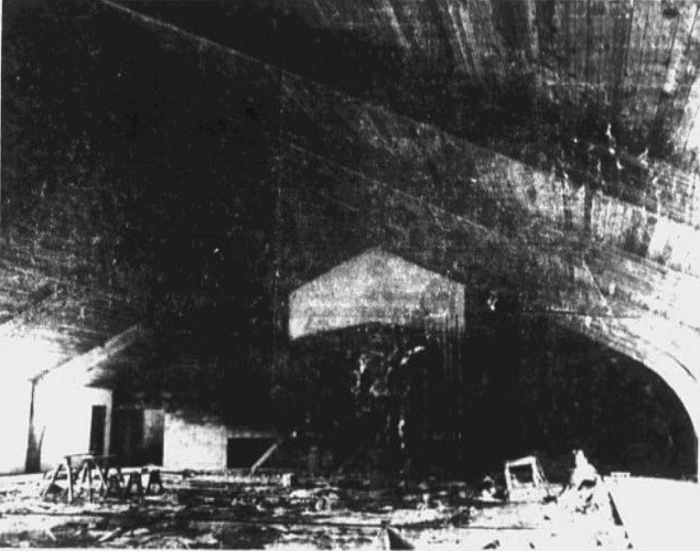 Inside the unfinished auditorium in November 1955. The exposed roof and unfinished floor show how much remained after the shell was built.
