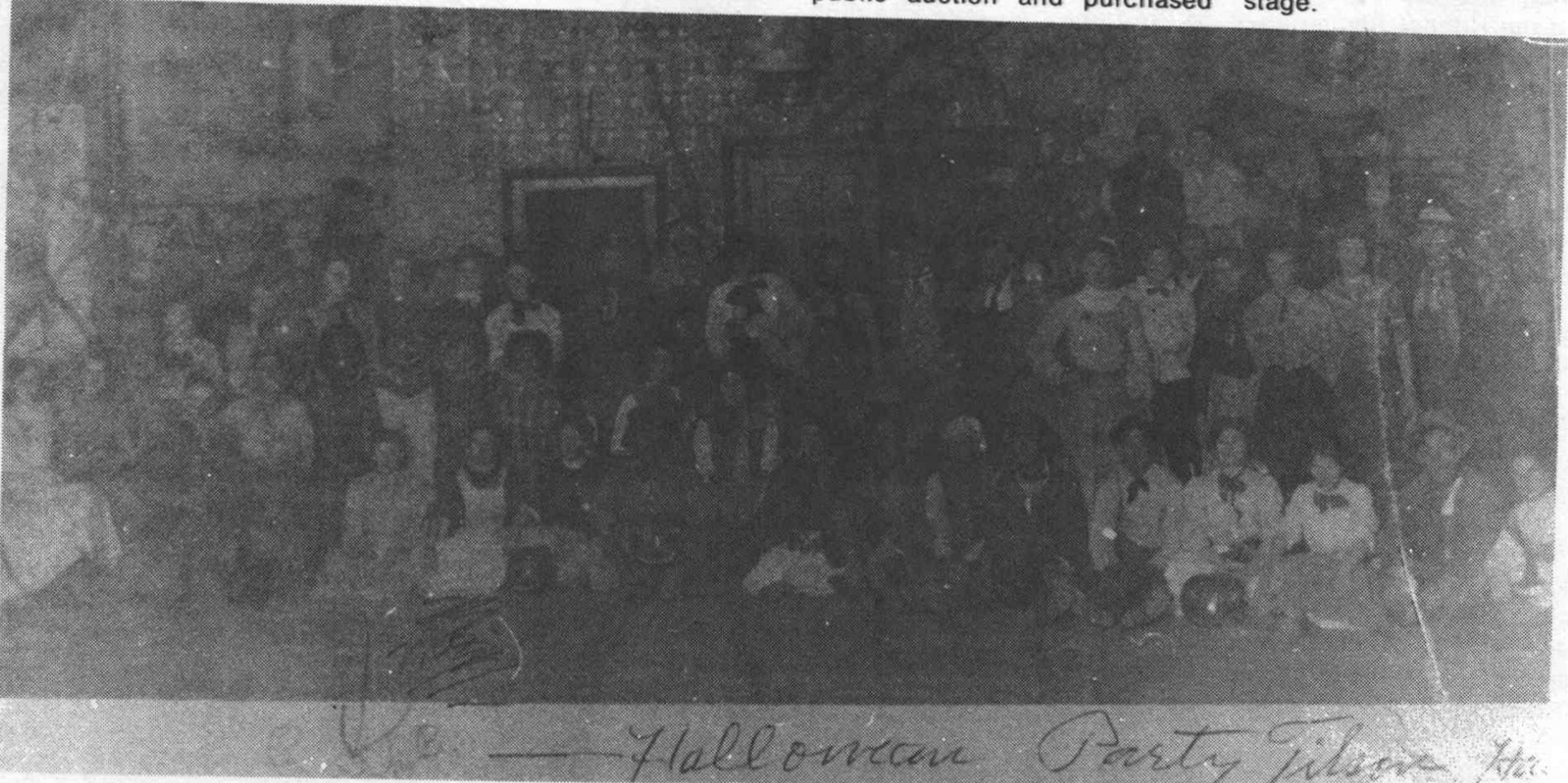 An undated gathering at Tilson’s Opera House. The handwritten inscription identifies a Halloween party; the centennial history does not supply the year or individual names.