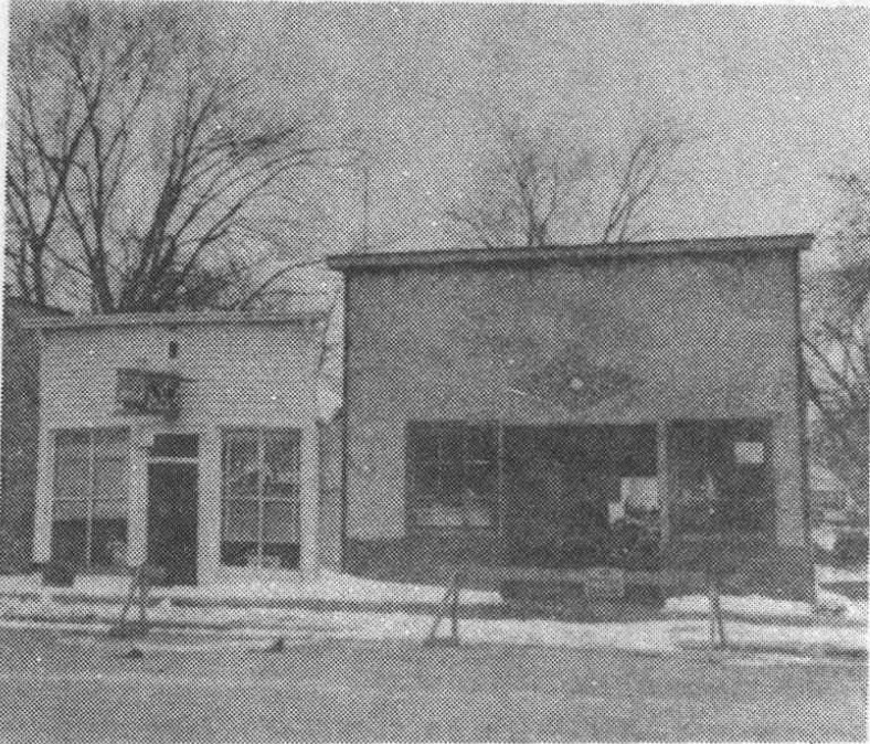 Remodeled low storefront and adjoining shop with bare trees behind them.