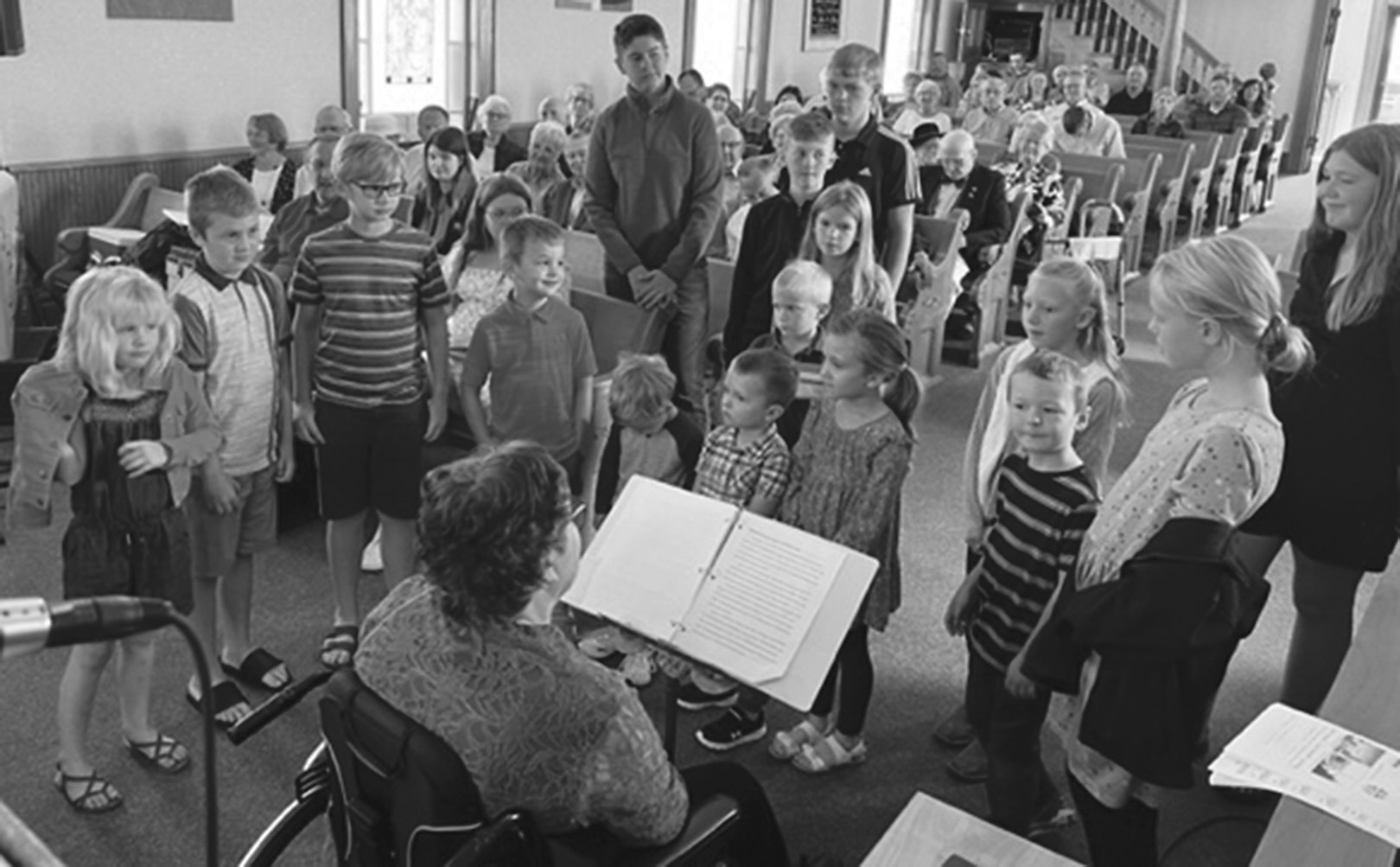 Children and adults gather at the front of the church during the 2022 Polka Sunday service.