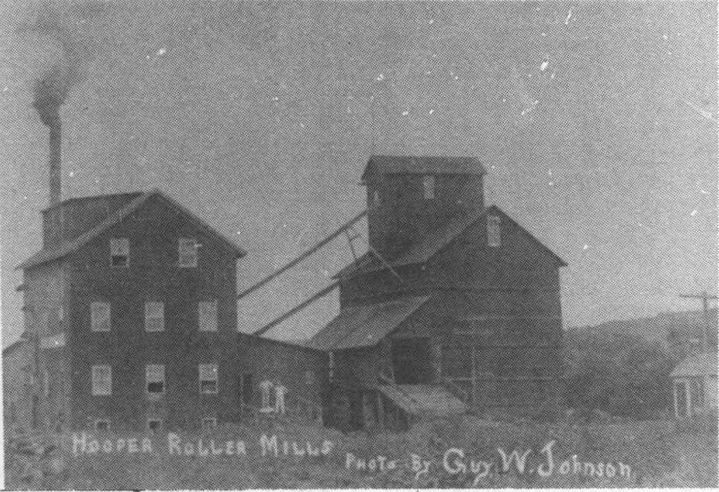 Hooper Roller Mills after enlargement and improvements; the printed photograph credits Guy W. Johnson.