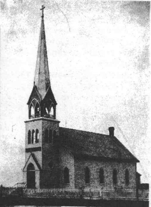 Historic photograph of St. Paul’s church with a tall steeple and fence.