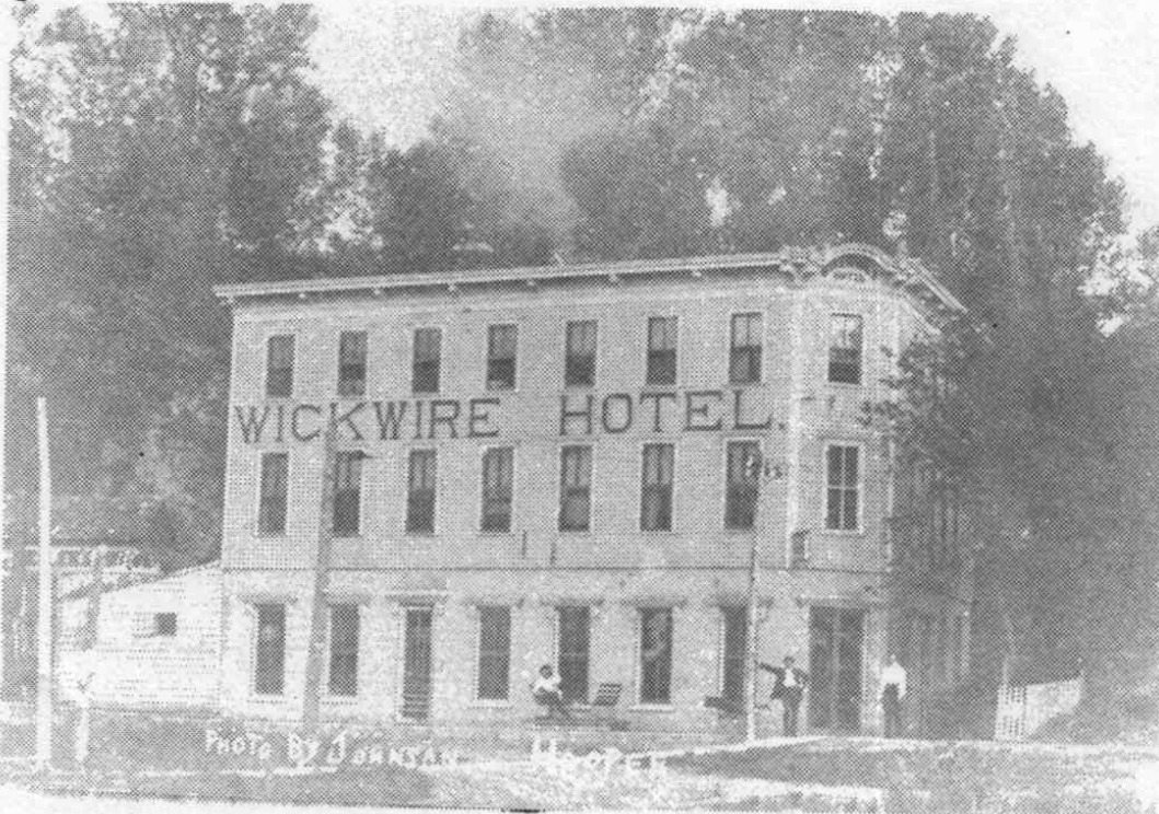 The three-story Wickwire Hotel with its name painted across the upper facade.