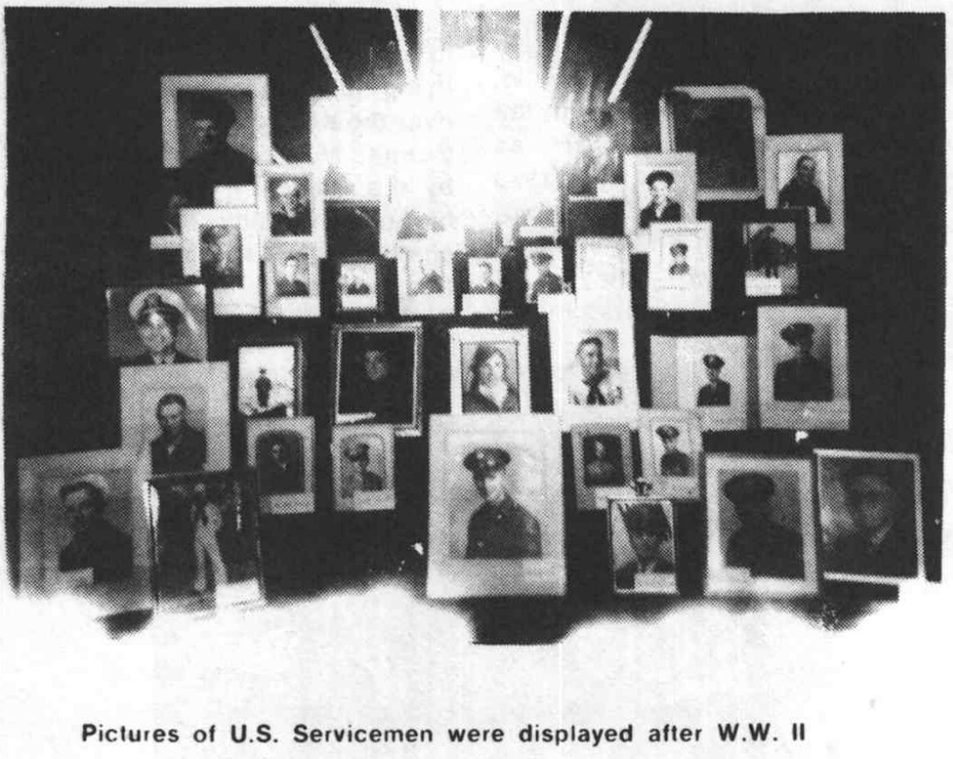 A black-and-white book photograph of a display of framed servicemen’s portraits.