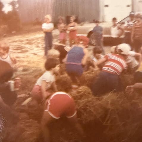 Coin hunt in straw, possibly Fourth of July or Ag Olympics, shared by Kim Ruwe Deprez