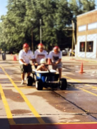 Participants in a downtown parade vehicle — details requested, shared by Susan Janssen
