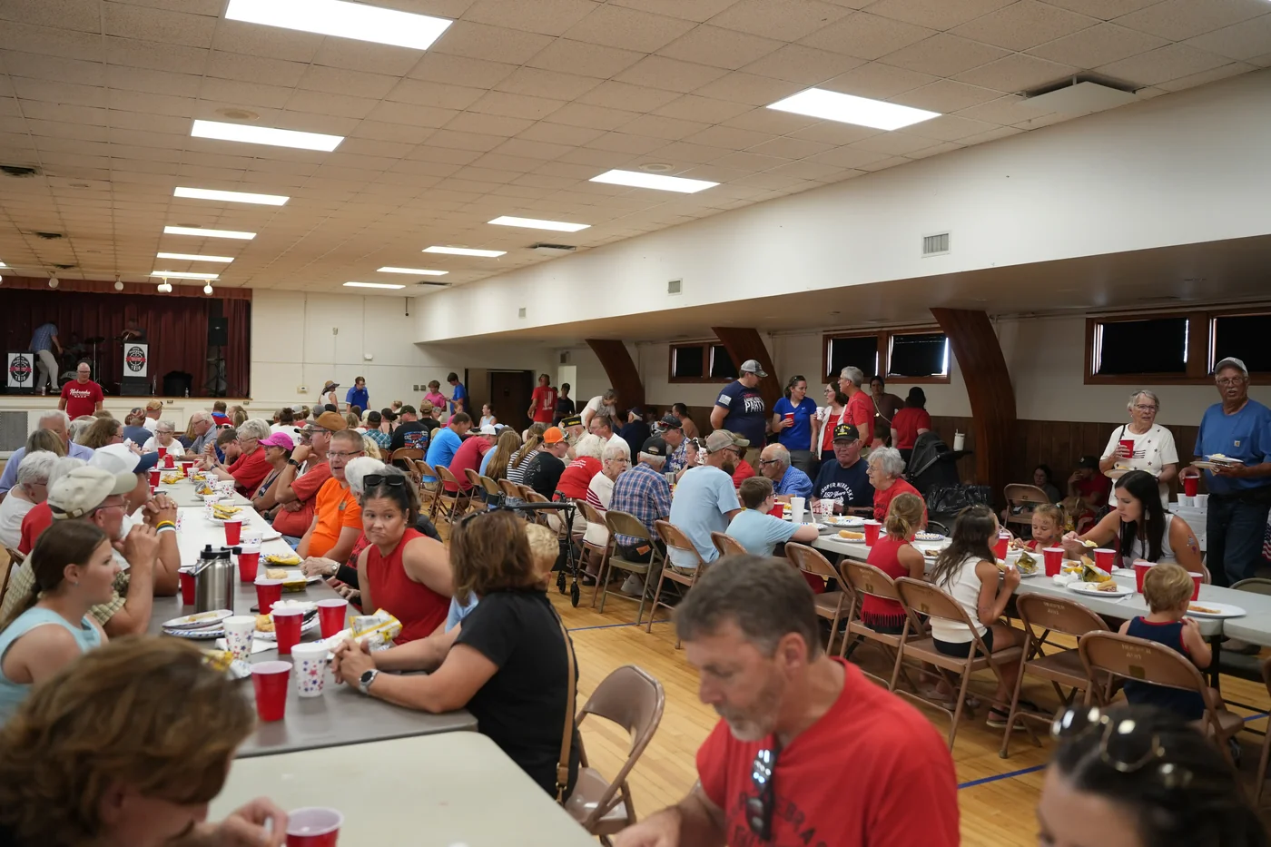 Neighbors sharing a meal at Hooper’s 150th celebration in 2026